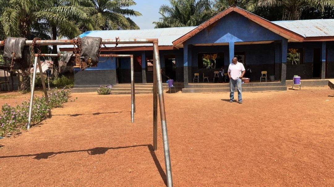 Sylvester standing in front of Kamawornie Nursery School