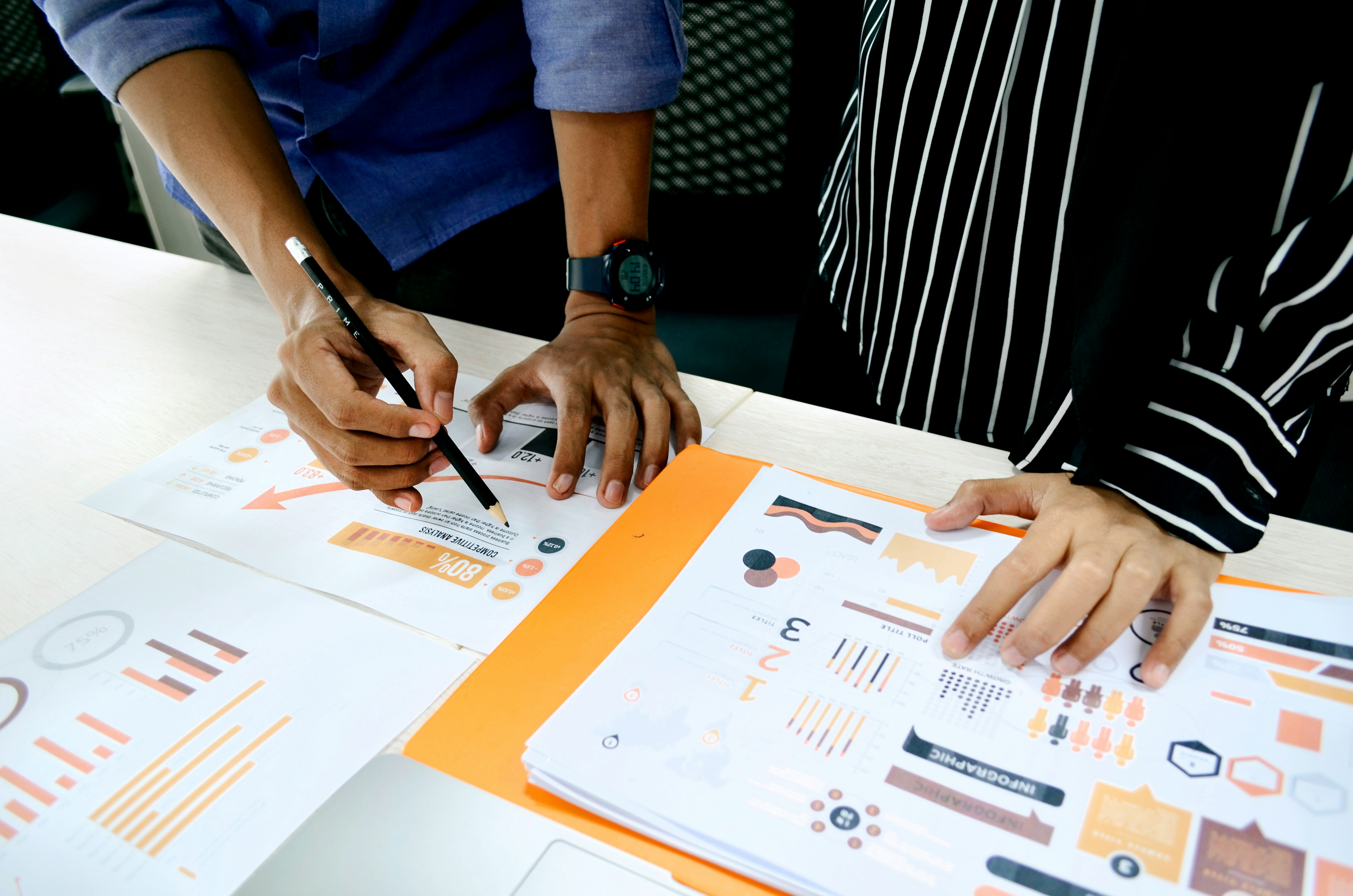 two men addressing and drawing on a chart